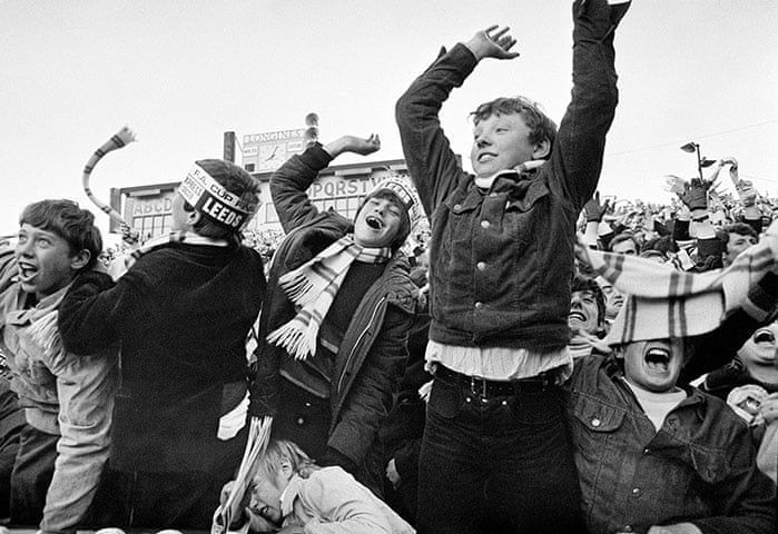 Leeds supporters celebrating together in a crowd scene.
