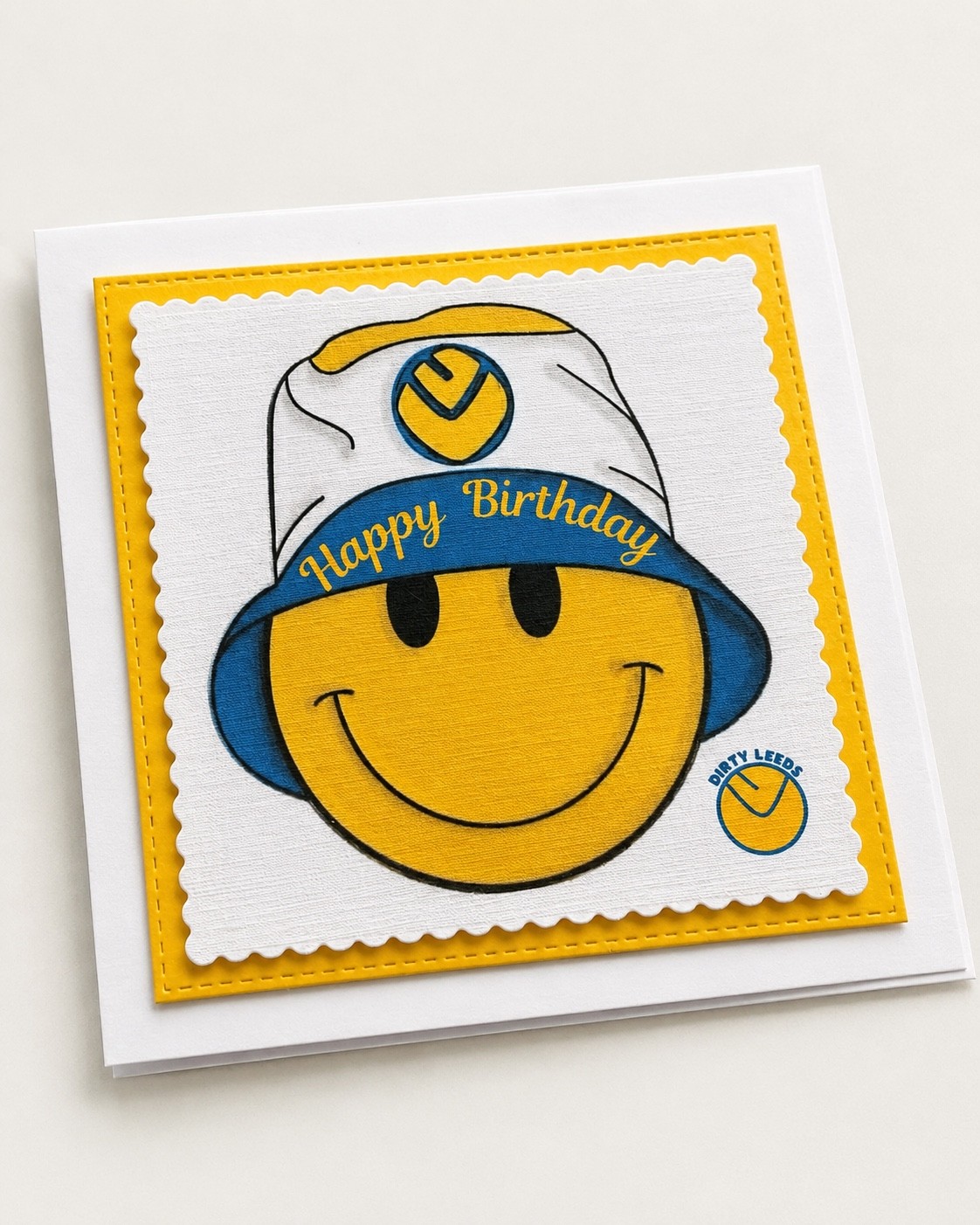 Dirty Leeds® Yellow Smiley Bucket Hat Happy Birthday Card – angled view.