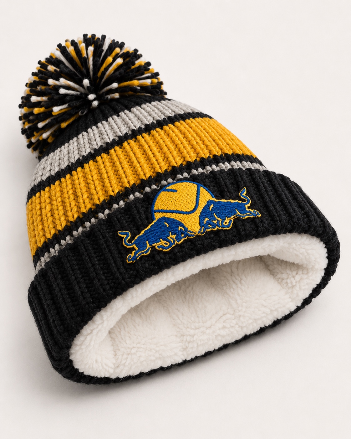 Leeds United Smiley Red Bull Emblem Striped Fur-Lined Bobble Hat – fleece lining detail.