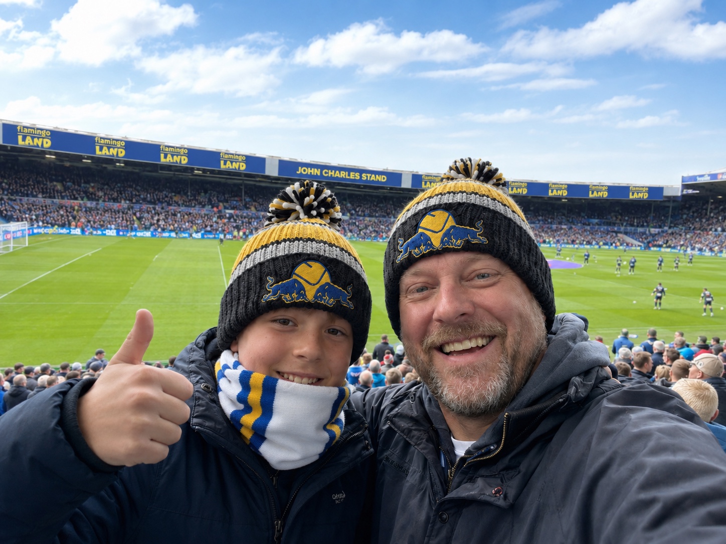 Leeds United Smiley Red Bull Emblem Striped Fur-Lined Bobble Hat – matchday setting.
