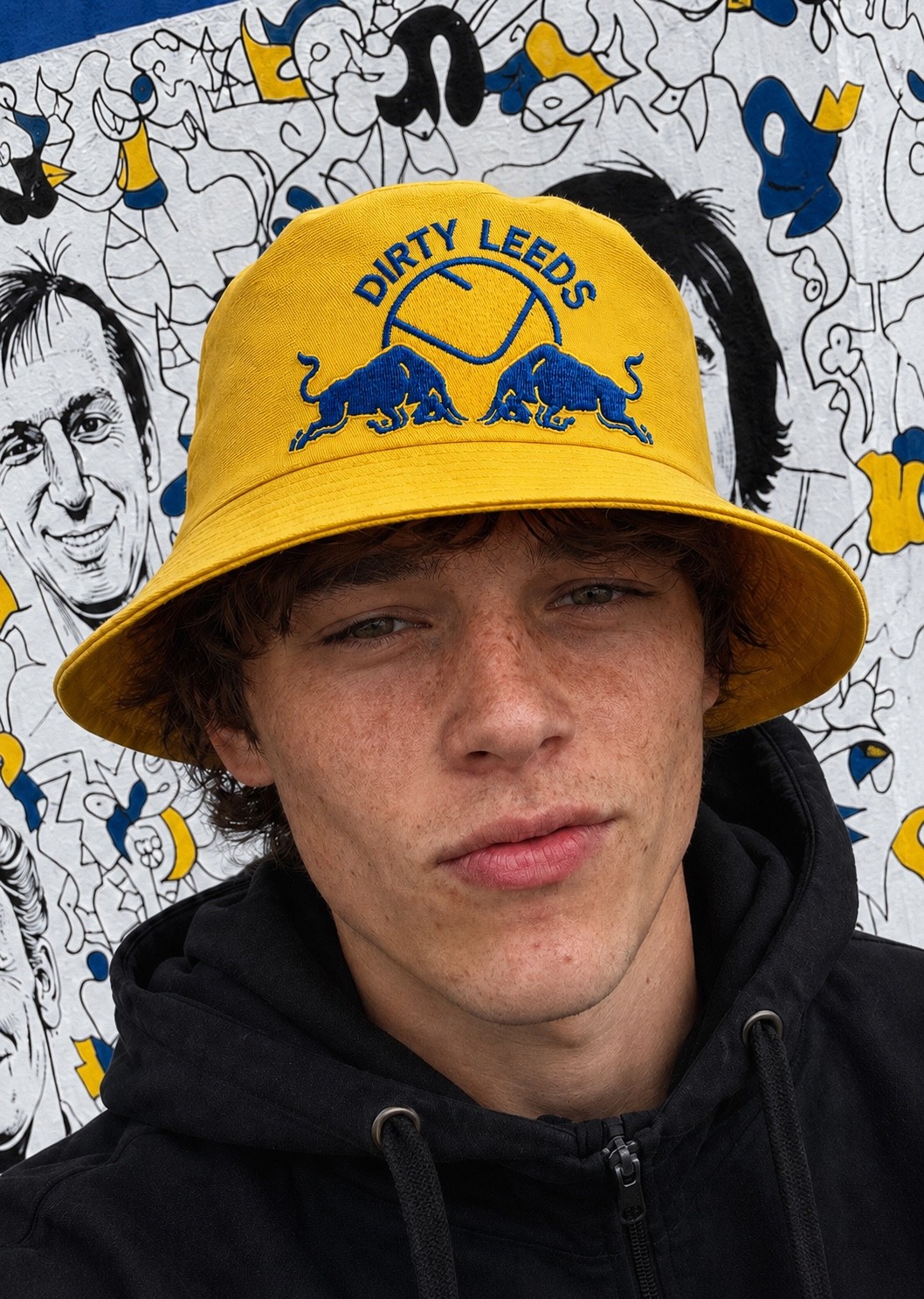 Dirty Leeds® Smiley Red Bull Emblem Yellow Bucket Hat – lifestyle image, close lifestyle image.