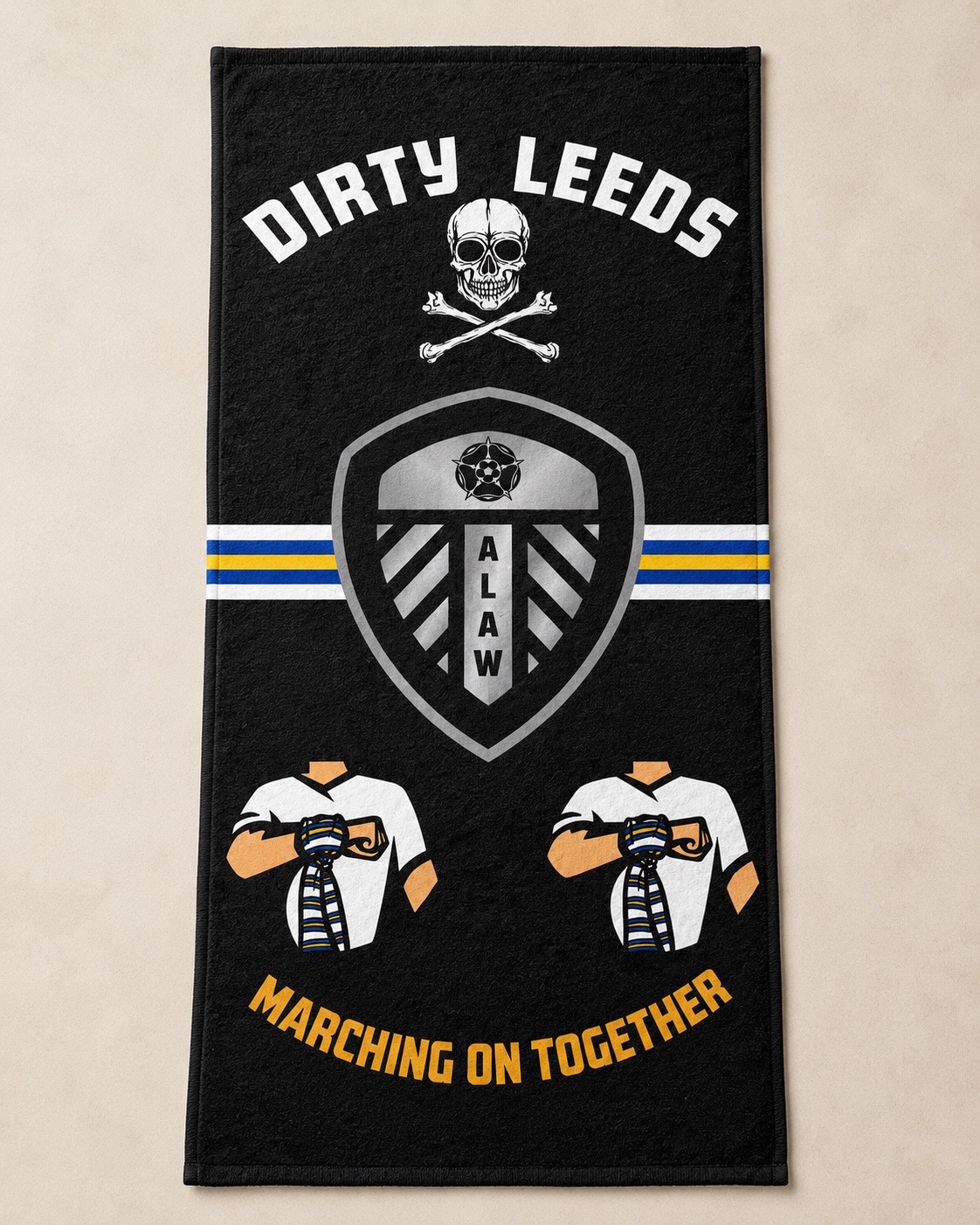 Dirty Leeds® ALAW MOT black beach towel shown flat on a stone coloured background.