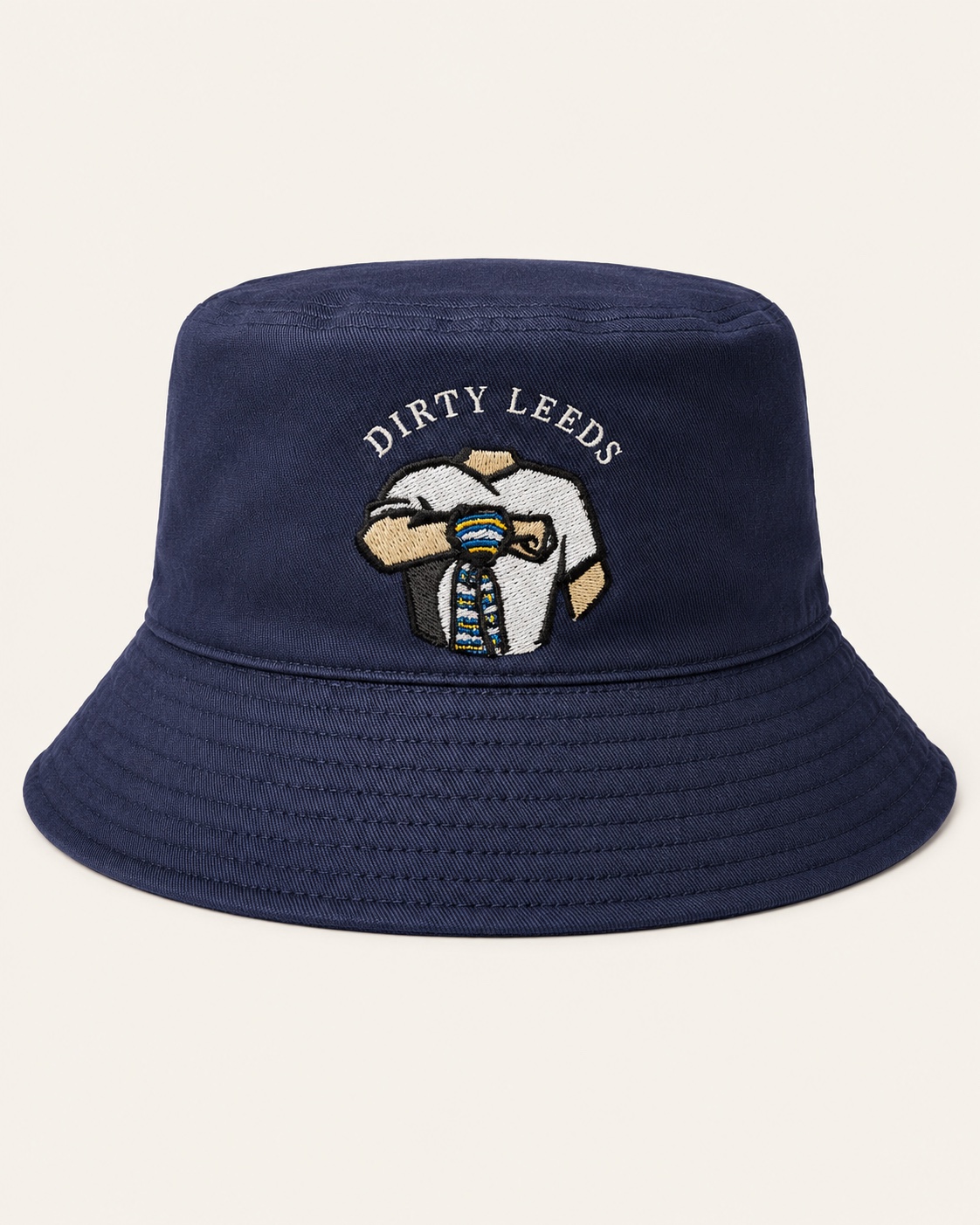 Front view of the Dirty Leeds® Navy Bucket Hat with white embroidered Dirty Leeds lettering and scarf salute graphic.