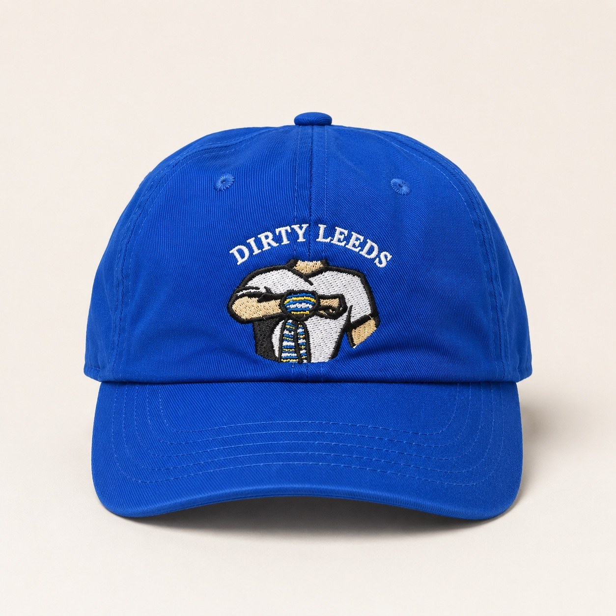 Front view of the blue Dirty Leeds® Original Logo Junior Baseball Cap with embroidered Keep Fighting salute logo and curved peak.