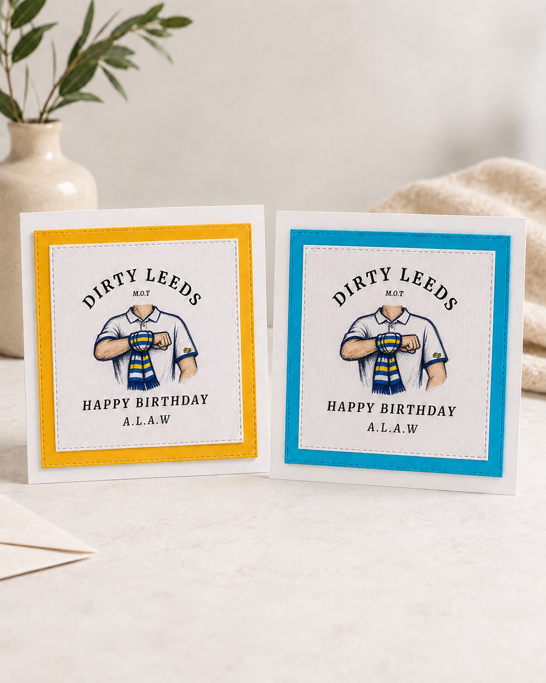 Blue and yellow Dirty Leeds® Salute Logo Happy Birthday Cards shown together.