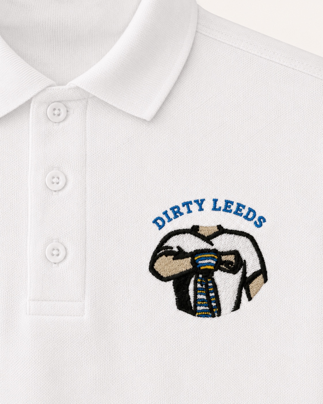 Dirty Leeds® White Embroidered Polo Shirt – front view, detail close-up.